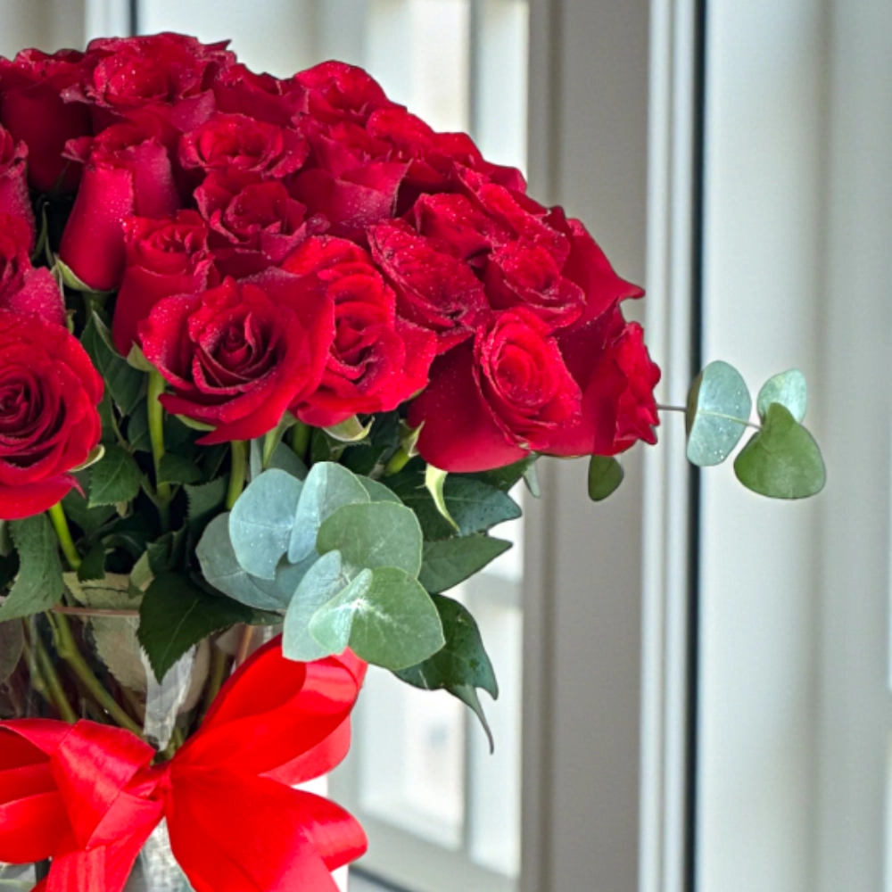 Bunch of 51 red rose with fillers in a glass vase