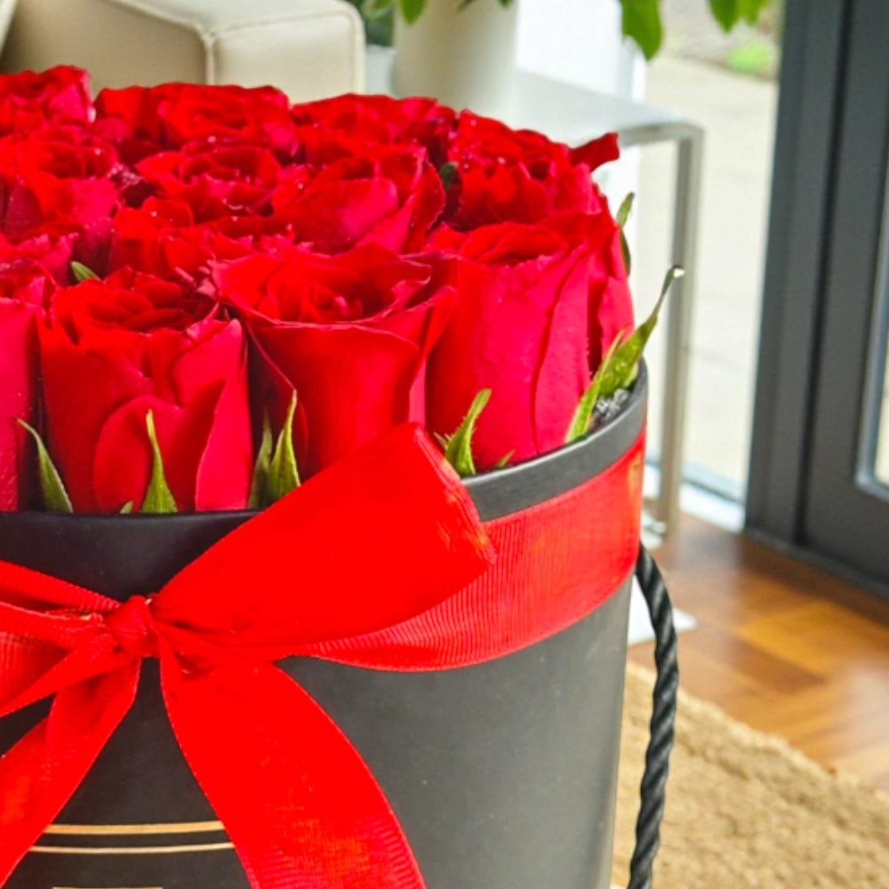 Arrangement of 20 red roses in a black box