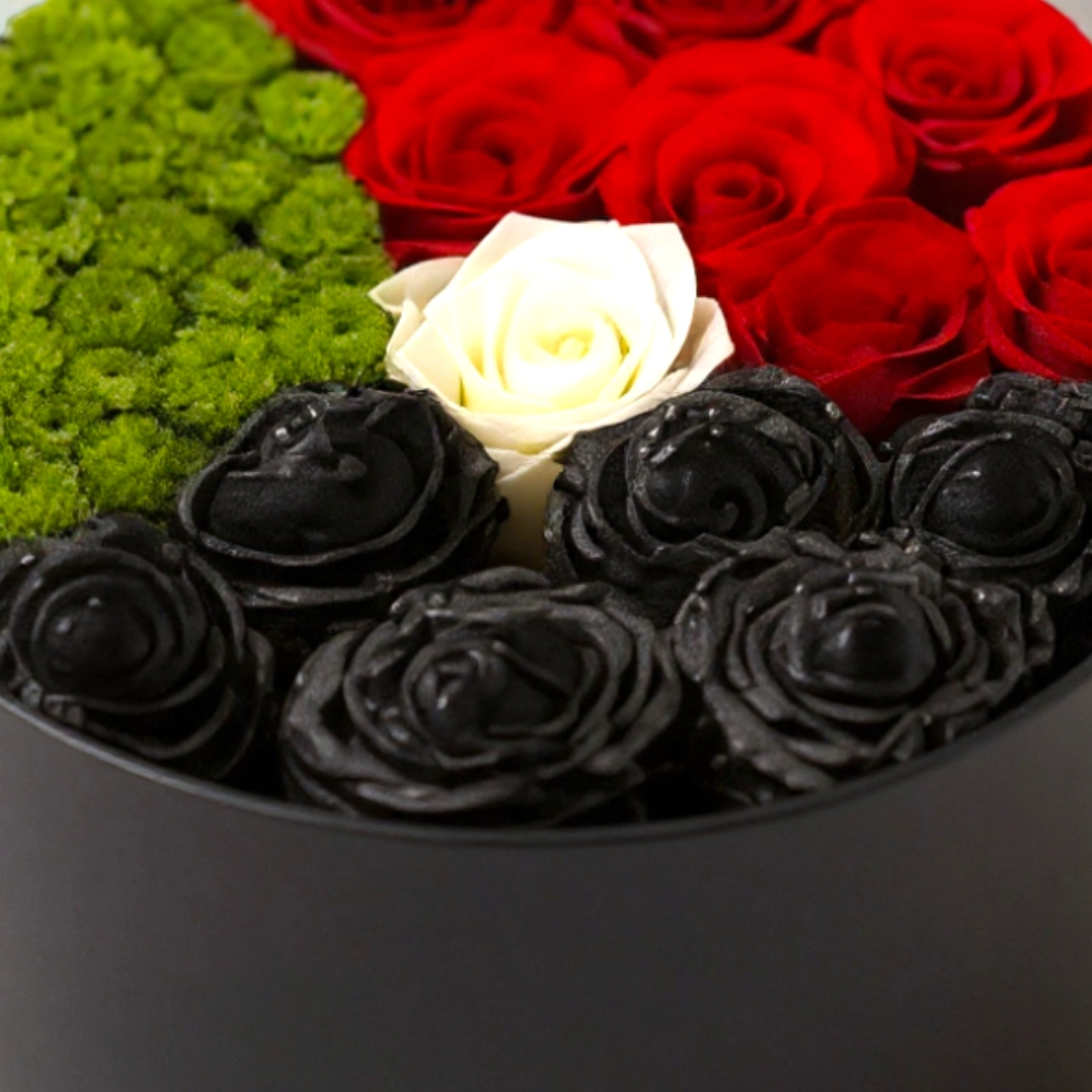 Arrangement of UAE color roses in a black box