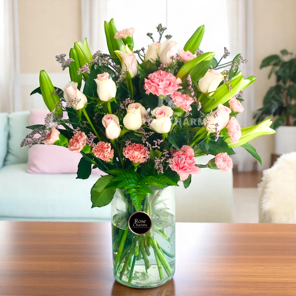 Arrangement of lilies, roses, carnation in a glass vase