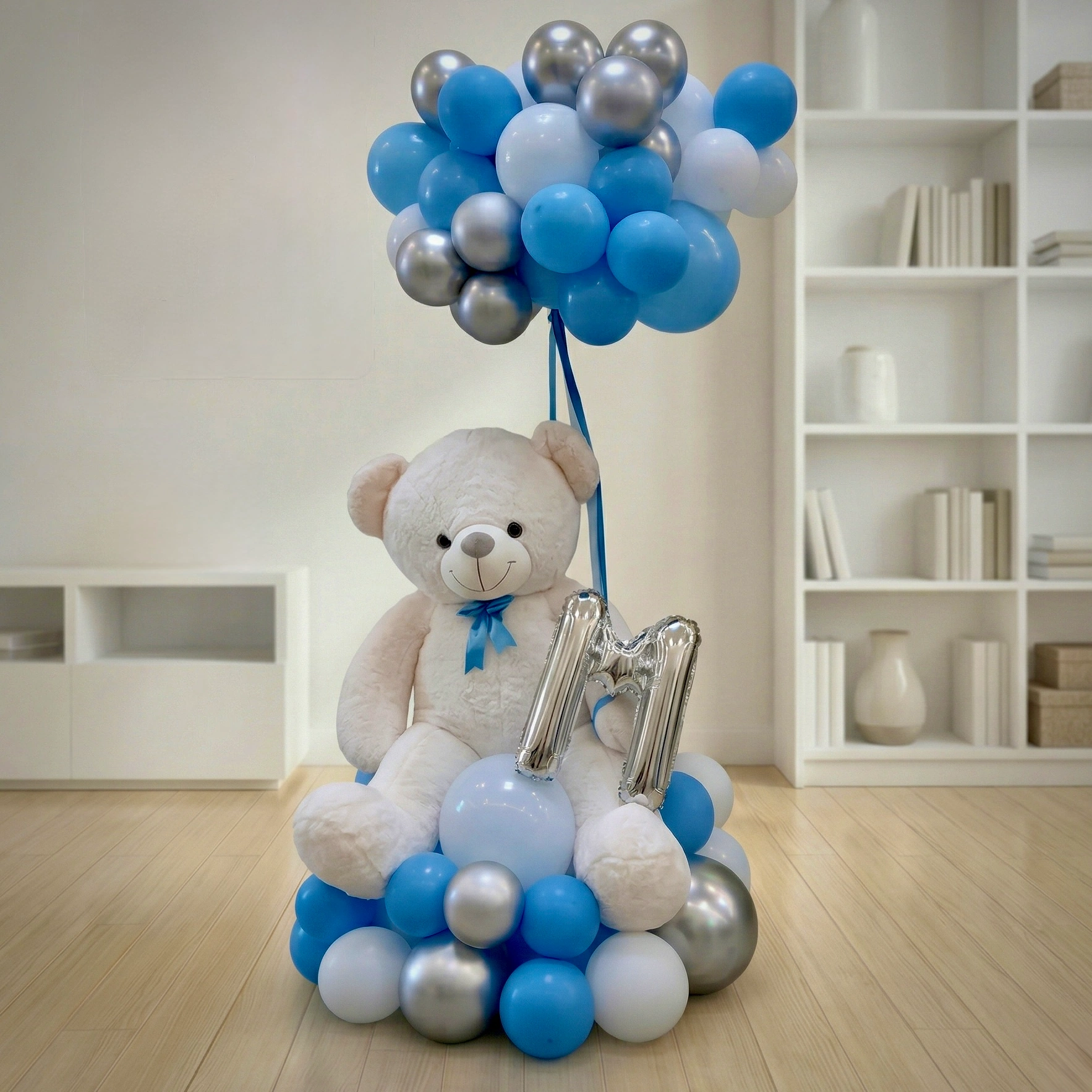 Baby boy balloon arrangement with 90cm teddy bear blue silver white balloons and personalized initial foil balloon